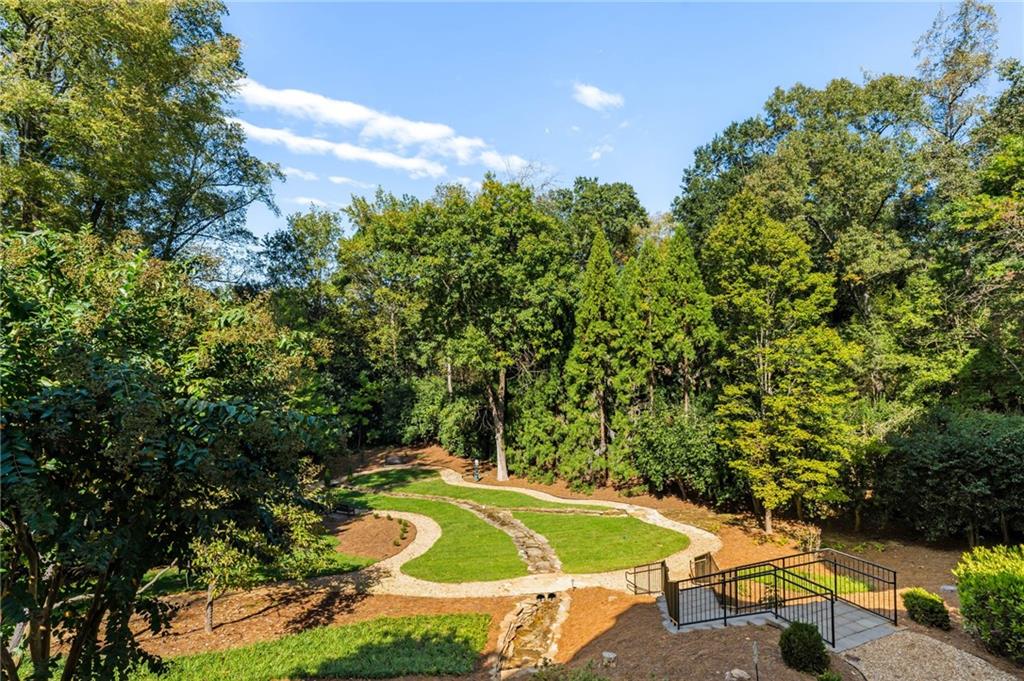 2440 Peachtree Road Northwest, Unit 6 Atlanta, GA 30305 - Photo 31 of 34 a view of a swimming pool with lawn chairs under an umbrella