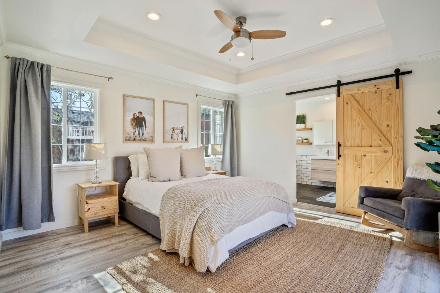 1851 Nash Drive San Mateo, CA 94401 - Photo 14 of 46 a bedroom with a large bed and a chandelier