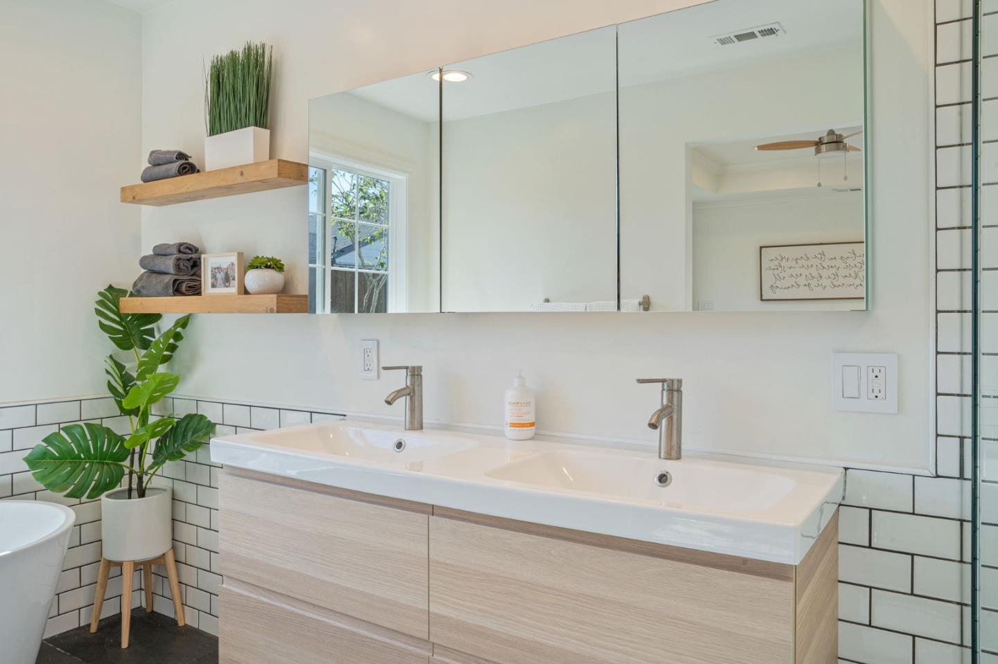 1851 Nash Drive San Mateo, CA 94401 - Photo 19 of 46 a bathroom with a sink a mirror and a potted plant