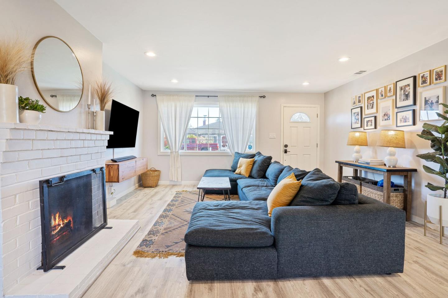 1851 Nash Drive San Mateo, CA 94401 - Photo 3 of 46 a living room with furniture a fireplace and a flat screen tv