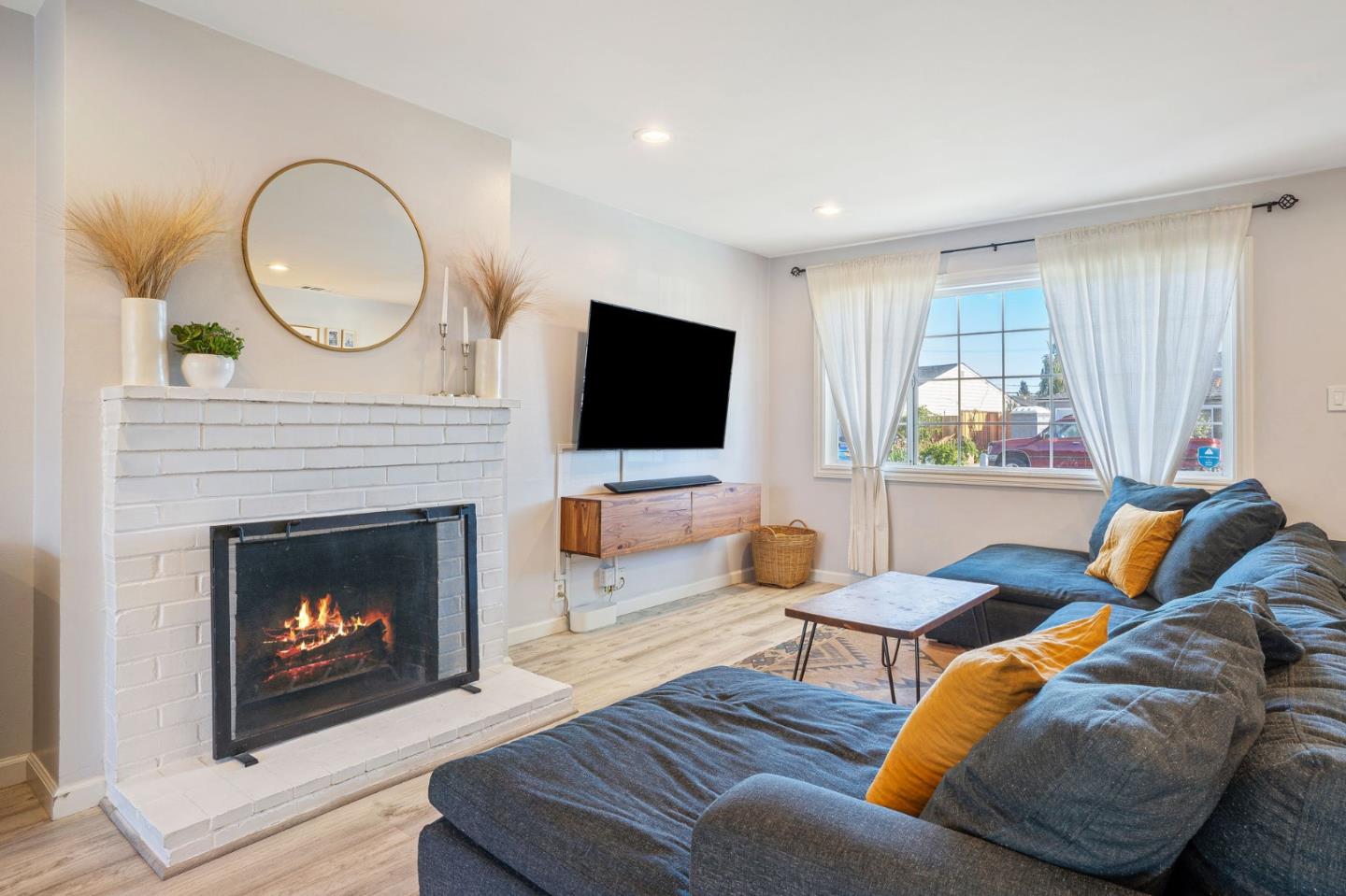 1851 Nash Drive San Mateo, CA 94401 - Photo 4 of 46 a living room with furniture a fireplace and a flat screen tv
