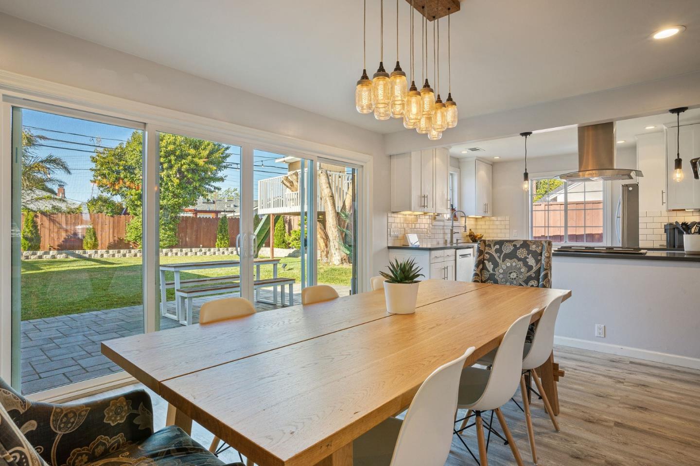 1851 Nash Drive San Mateo, CA 94401 - Photo 7 of 46 a dining room with furniture a chandelier and wooden floor