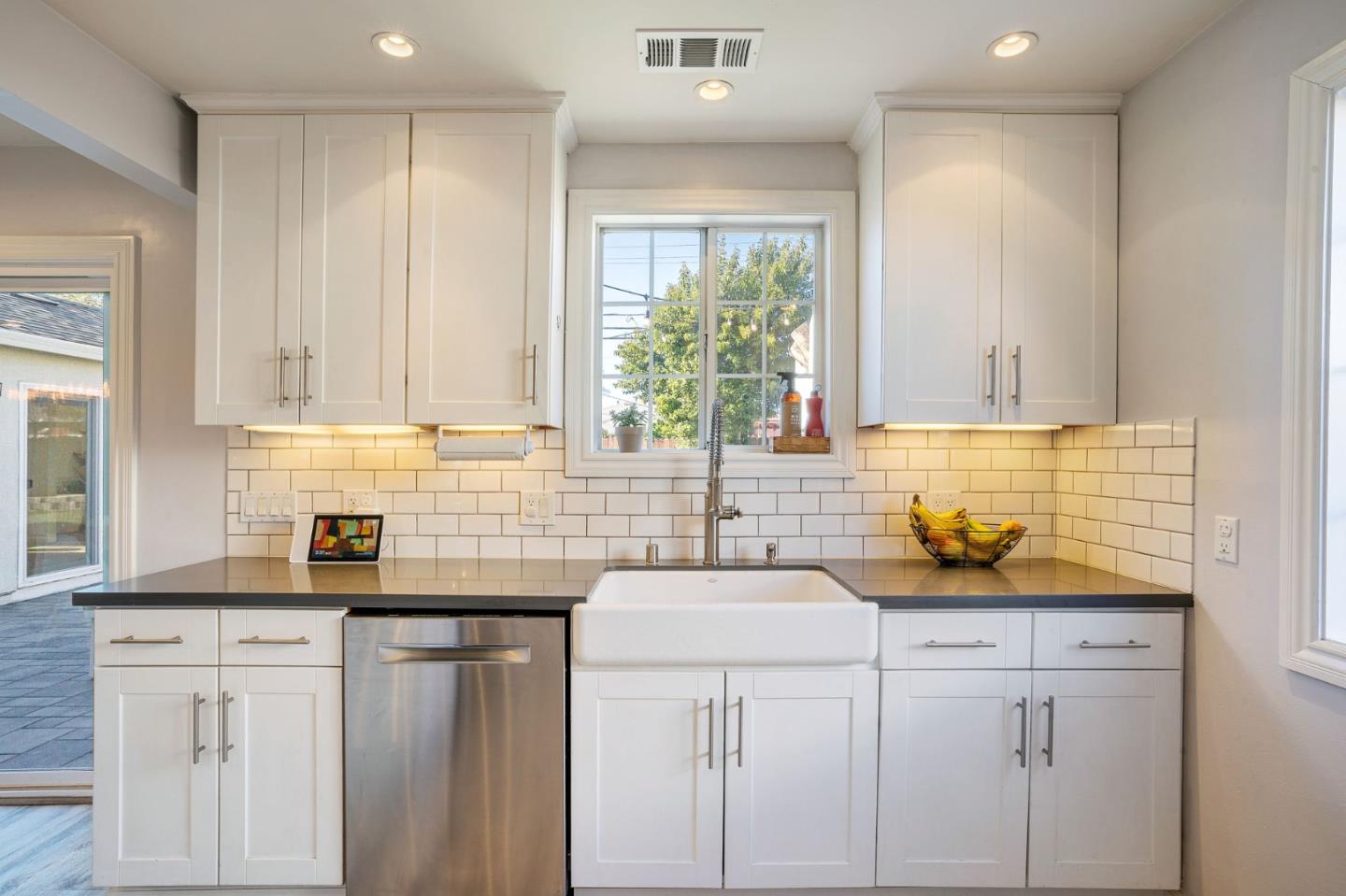 1851 Nash Drive San Mateo, CA 94401 - Photo 10 of 46 a kitchen with stainless steel appliances granite countertop white cabinets sink and window