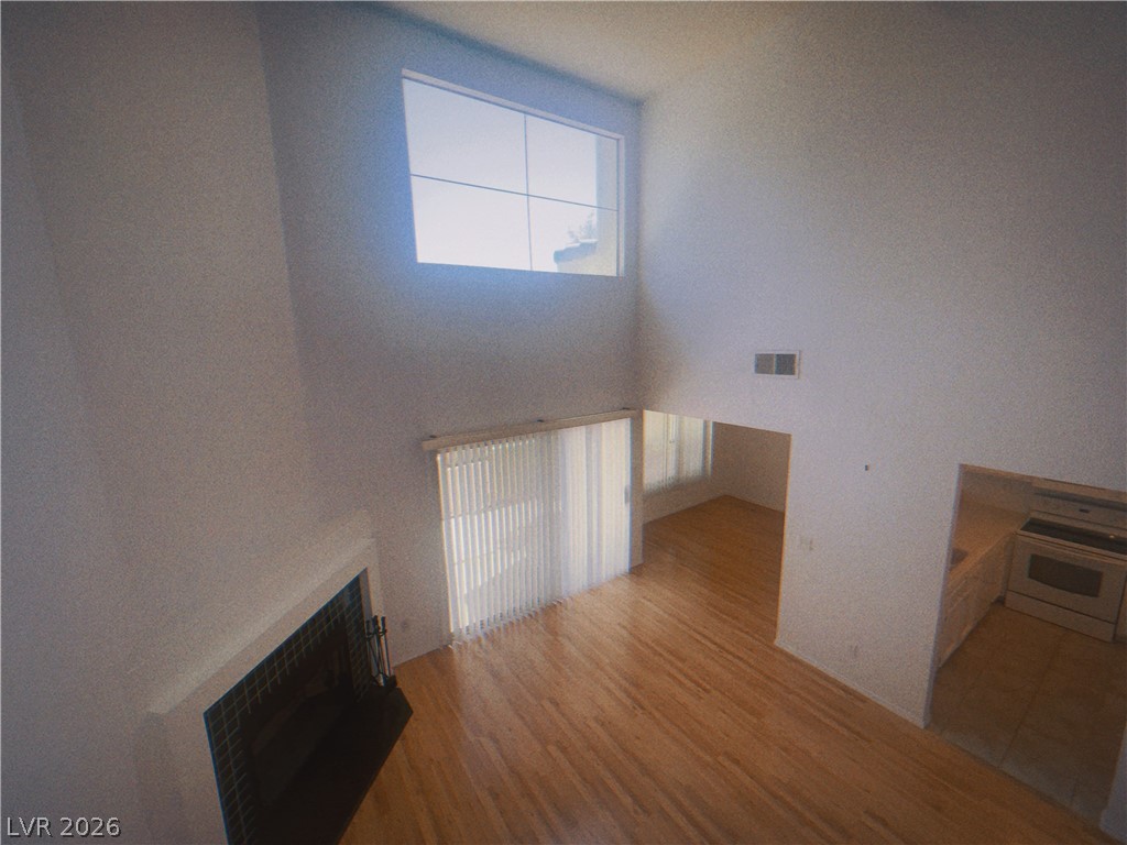 6250 West Flamingo Road, Unit 60 Las Vegas, NV 89103 - Photo 14 of 23 This living area features a soaring ceiling, an elegant fireplace, and rich hardwood flooring.