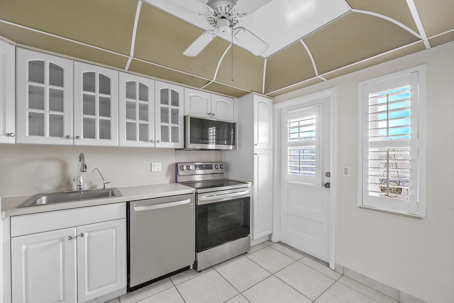 2871 North Ocean Boulevard, Unit F429 Boca Raton, FL 33431 - Photo 12 of 38 a kitchen with stainless steel appliances a stove sink and cabinets
