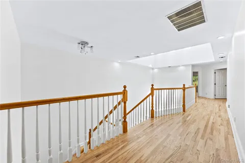 a view of an empty room with a kitchen and a sink