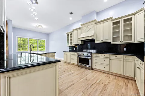 a kitchen with stainless steel appliances granite countertop a stove and a refrigerator