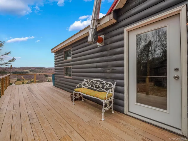 a view of balcony with wooden floor and fence