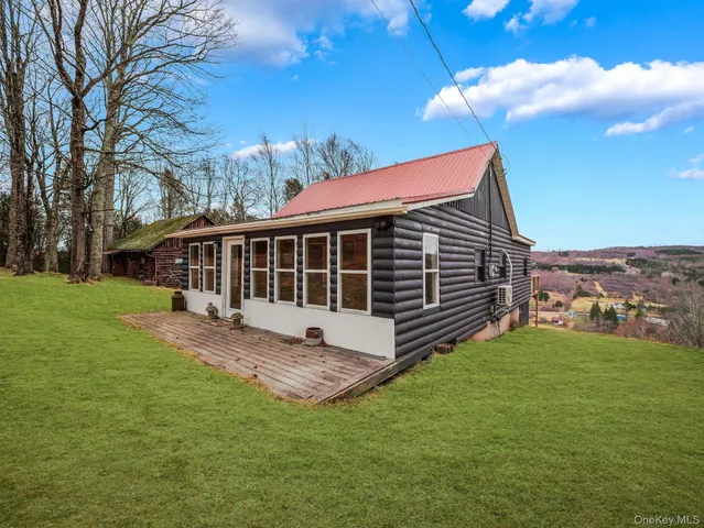 a front view of a house with a garden and deck