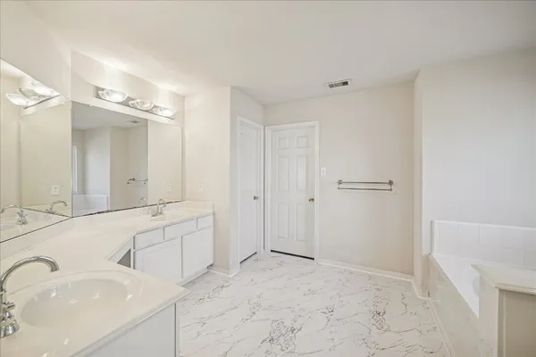 a large bathroom with a sink and a mirror