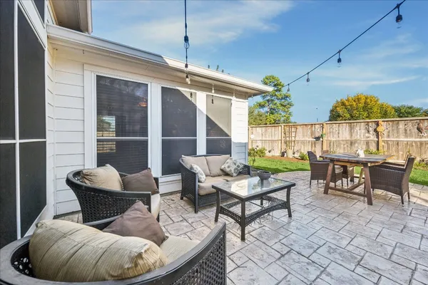 a dining room with furniture and a floor to ceiling window