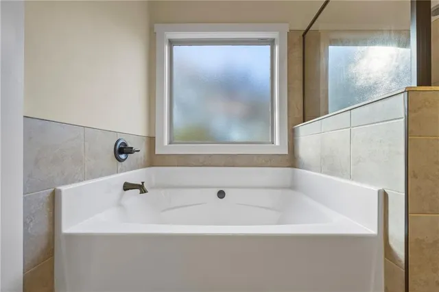 a white bath tub sitting next to a white sink