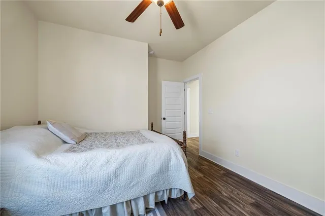 a bedroom with a bed and a ceiling fan