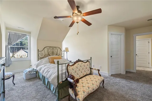 a bathroom with a granite countertop toilet sink and mirror