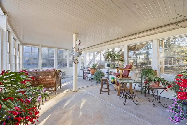 a living room filled with furniture and floor to ceiling windows