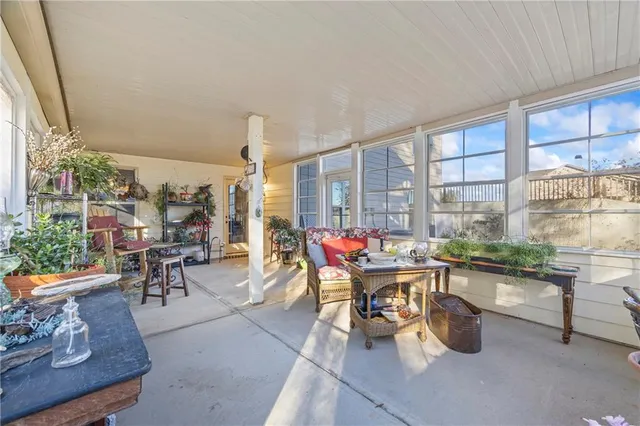 a view of a house with a wooden deck and a big yard