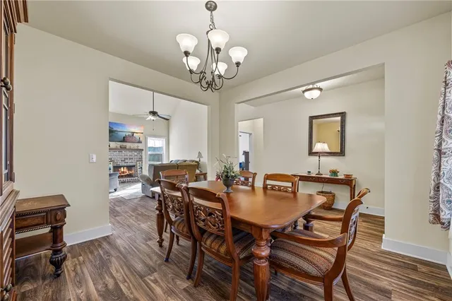 a view of a dining room with furniture wooden floor and chandelier