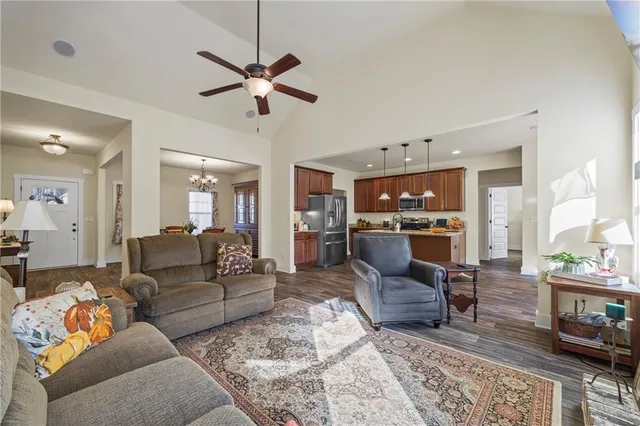 a living room with furniture ceiling fan and a rug