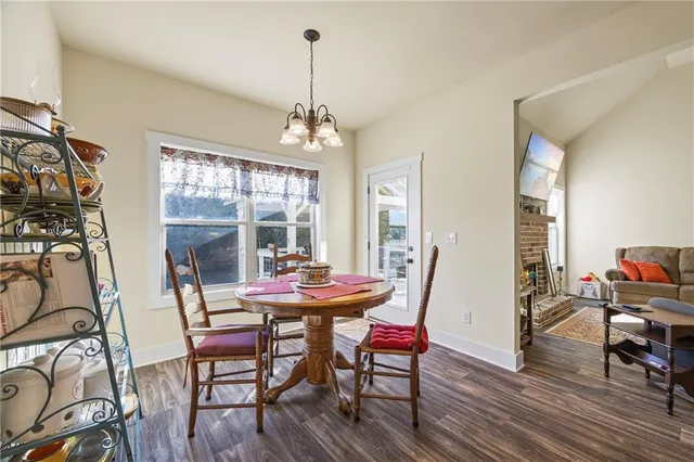 a view of a dining room with furniture wooden floor and a chandelier