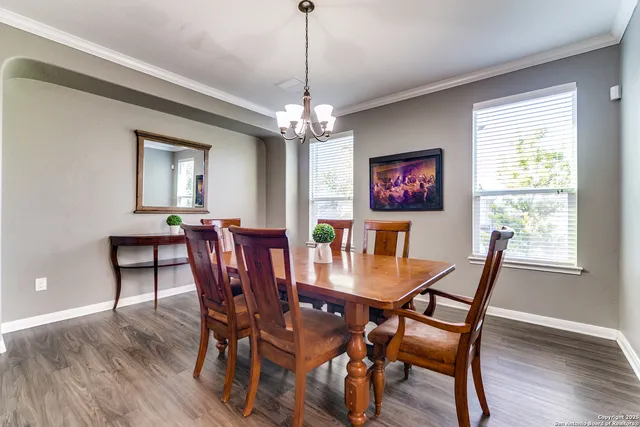 a view of a dining room with furniture window and wooden floor