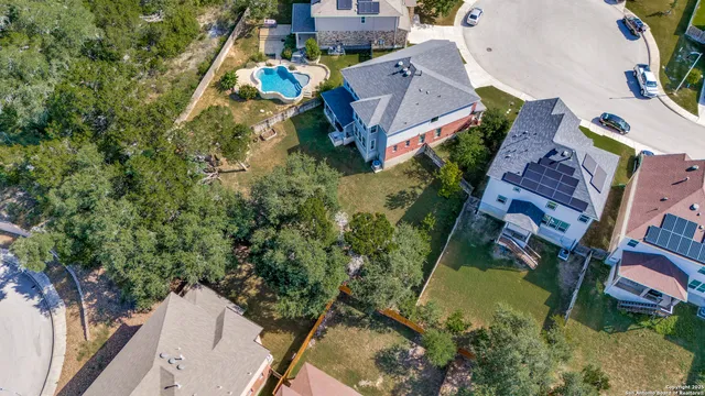an aerial view of multiple houses with yard