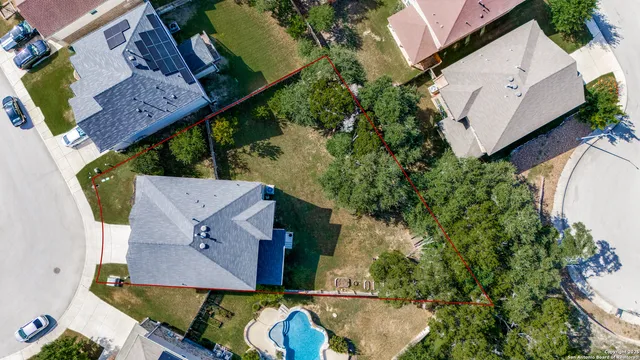 an aerial view of a house with a yard pool patio and outdoor seating