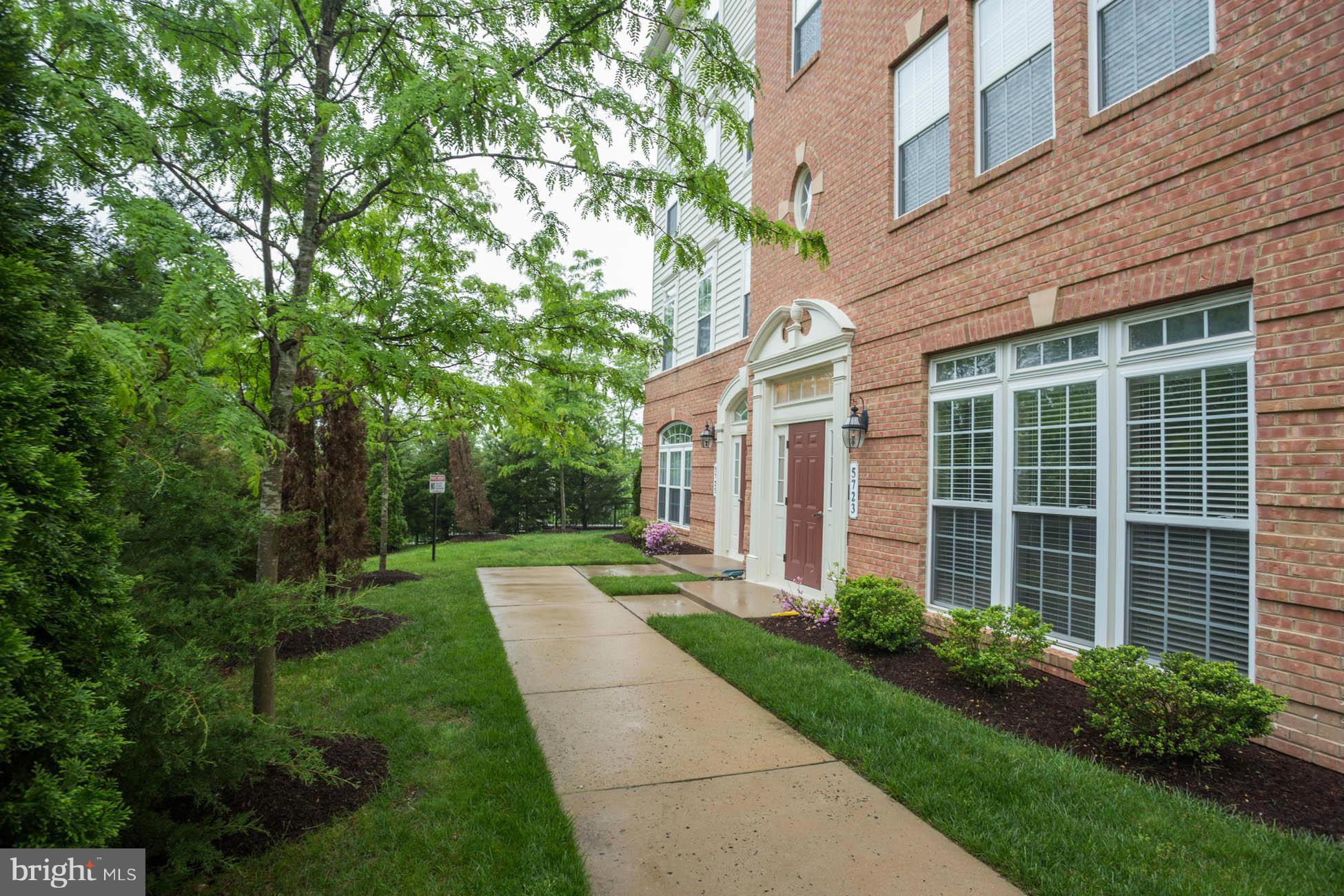 5723 Callcott Way, Unit M Alexandria, VA 22312 - Photo 2 of 28 a front view of a house with garden