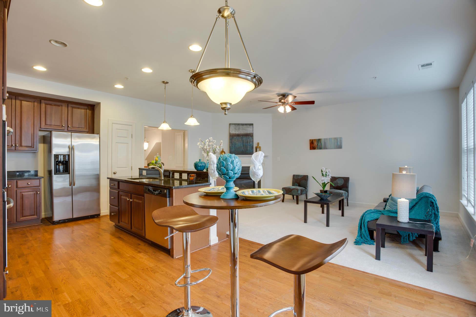 5723 Callcott Way, Unit M Alexandria, VA 22312 - Photo 14 of 28 a view of a dining room with furniture and chandelier
