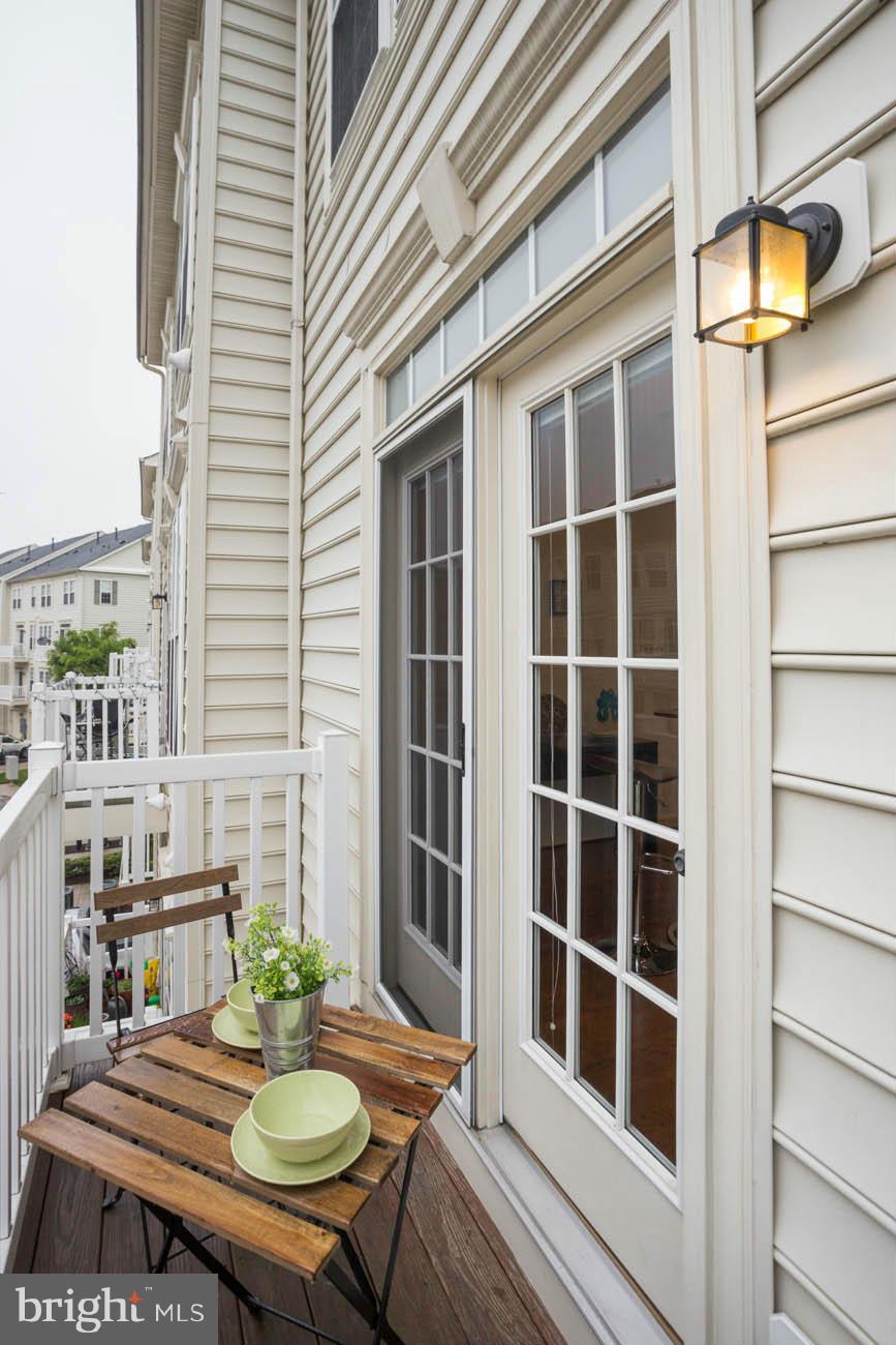5723 Callcott Way, Unit M Alexandria, VA 22312 - Photo 16 of 28 a backyard of a house with table and chairs