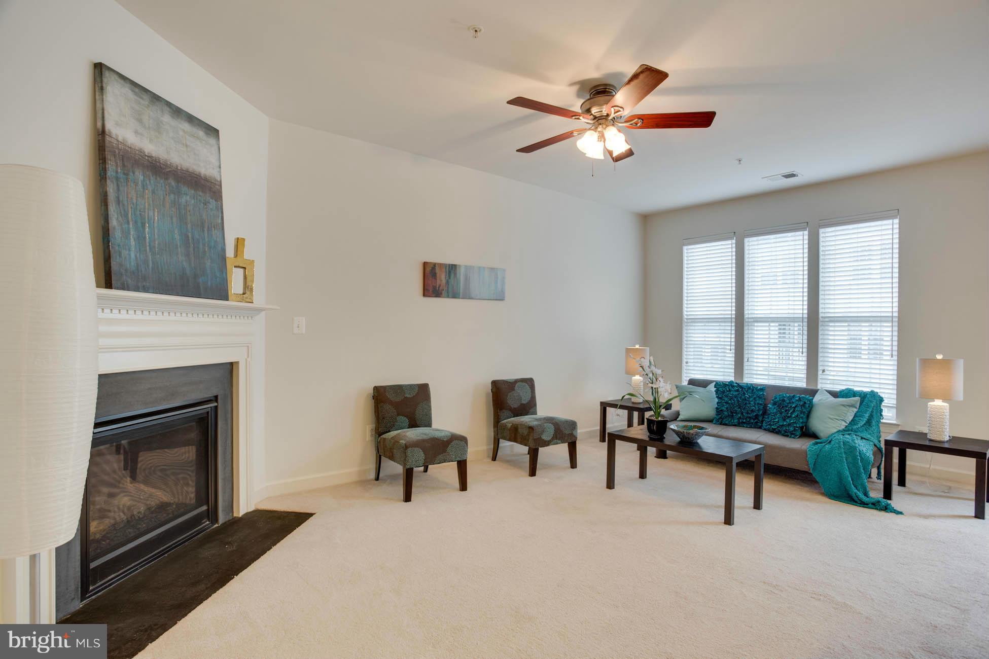 5723 Callcott Way, Unit M Alexandria, VA 22312 - Photo 17 of 28 a living room with furniture and a fireplace