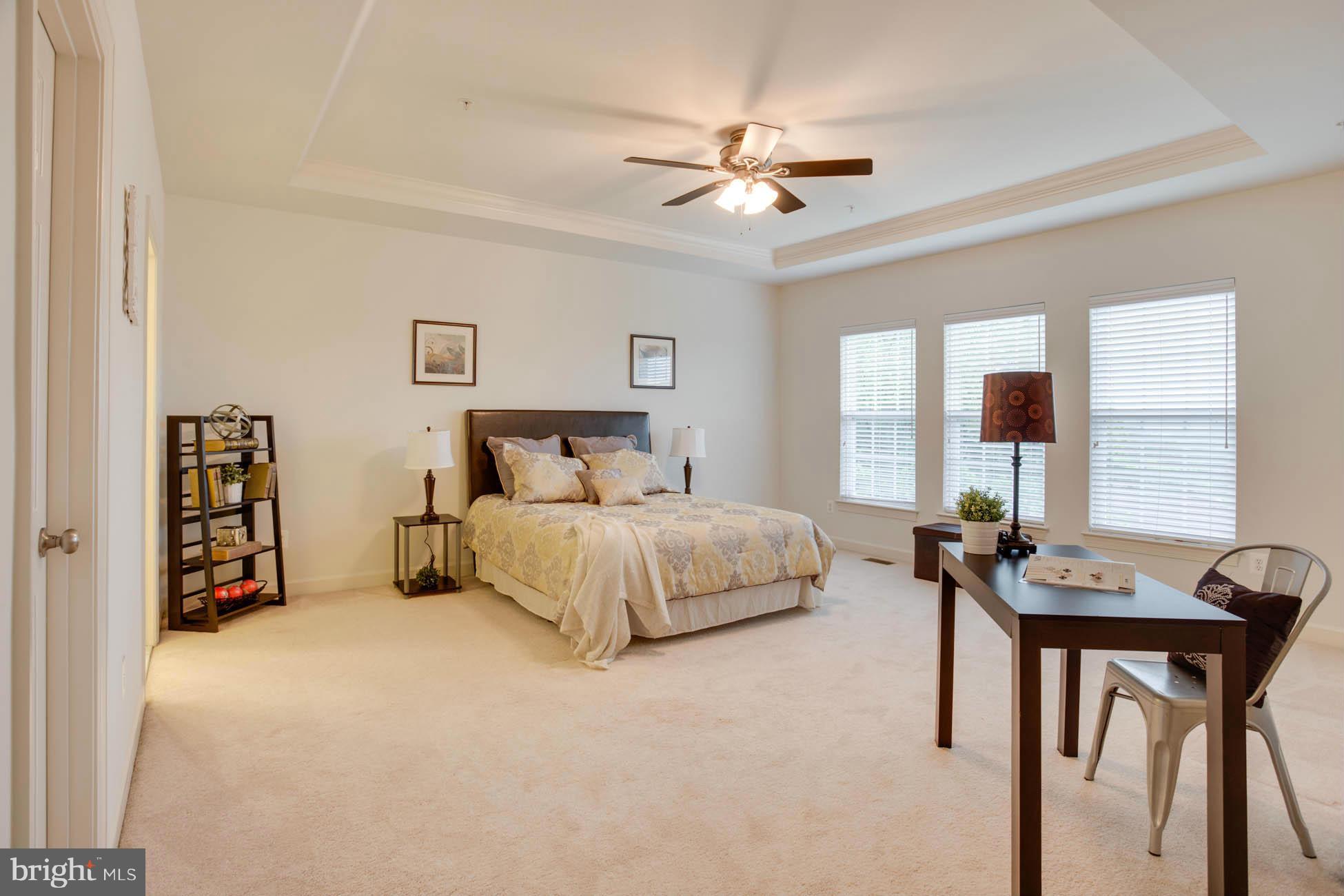 5723 Callcott Way, Unit M Alexandria, VA 22312 - Photo 18 of 28 a bedroom with a bed and a chandelier