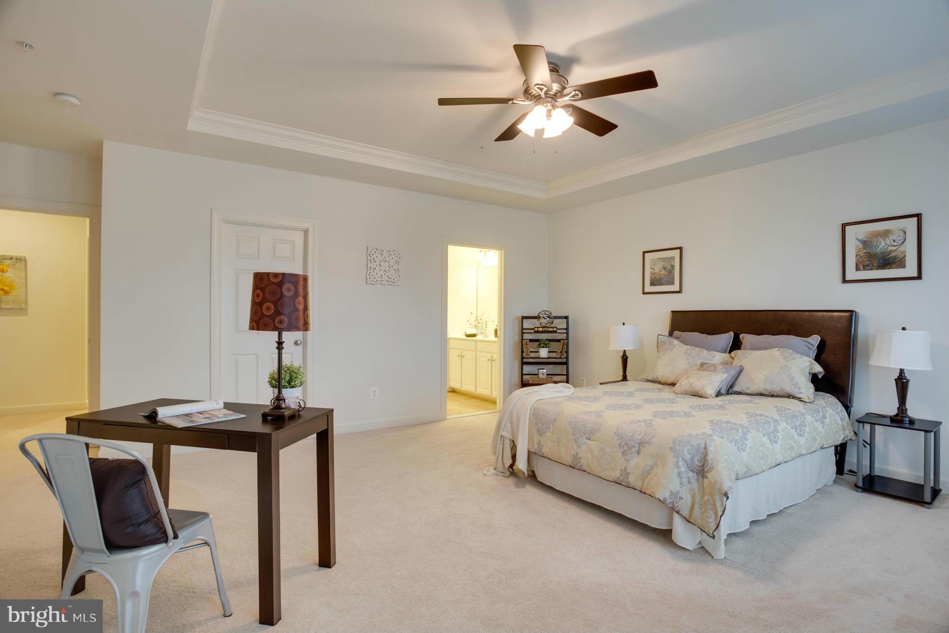 5723 Callcott Way, Unit M Alexandria, VA 22312 - Photo 19 of 28 a bedroom with a bed and a table
