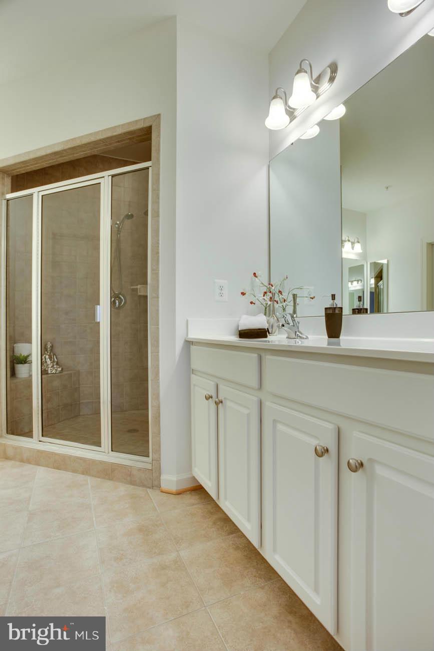 5723 Callcott Way, Unit M Alexandria, VA 22312 - Photo 20 of 28 a bathroom with a double vanity sink and a mirror