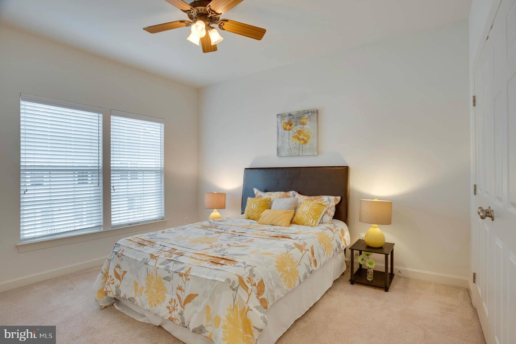 5723 Callcott Way, Unit M Alexandria, VA 22312 - Photo 23 of 28 a bedroom with a bed and a chandelier