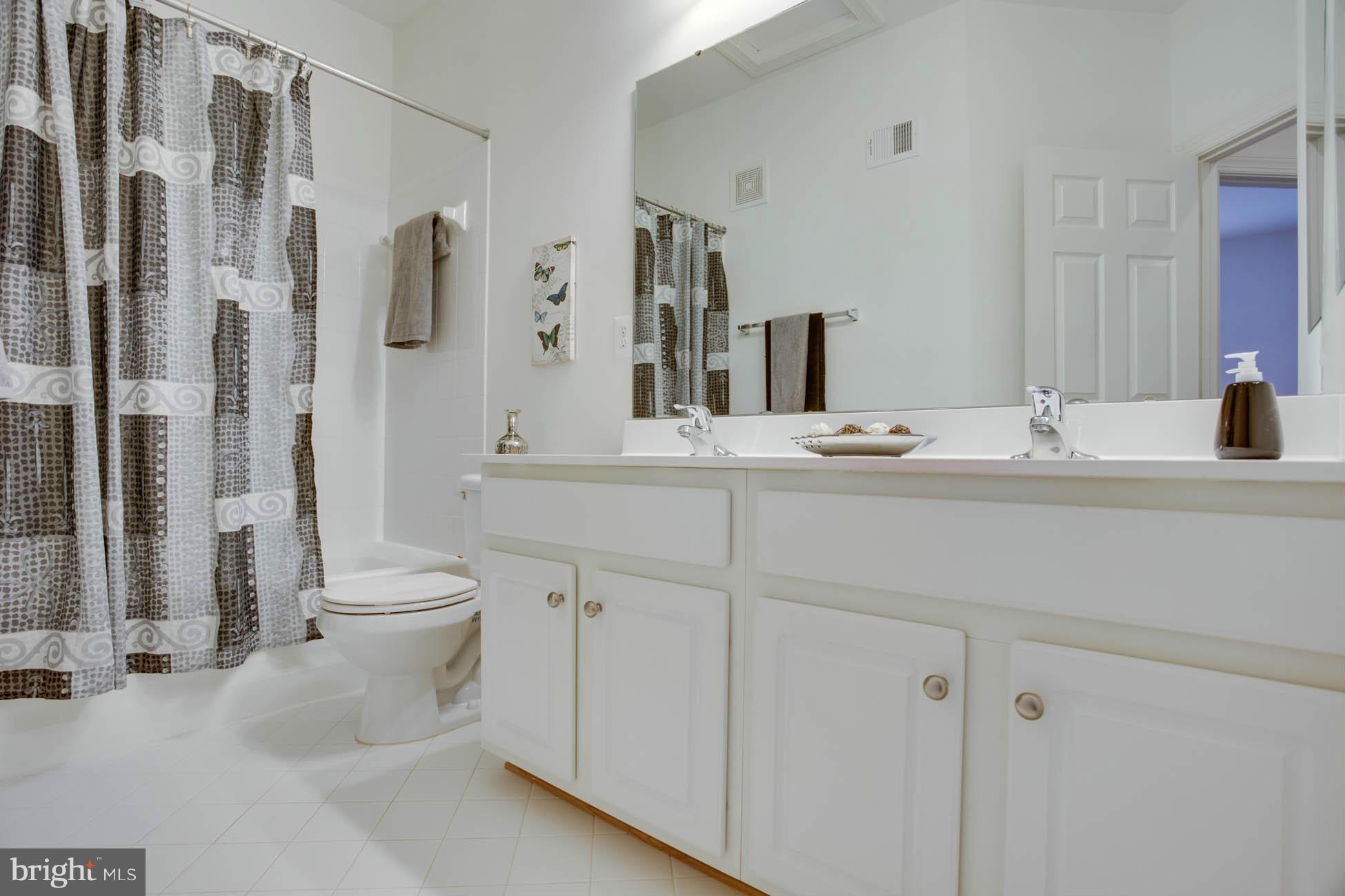 5723 Callcott Way, Unit M Alexandria, VA 22312 - Photo 25 of 28 a bathroom with a sink toilet and shower