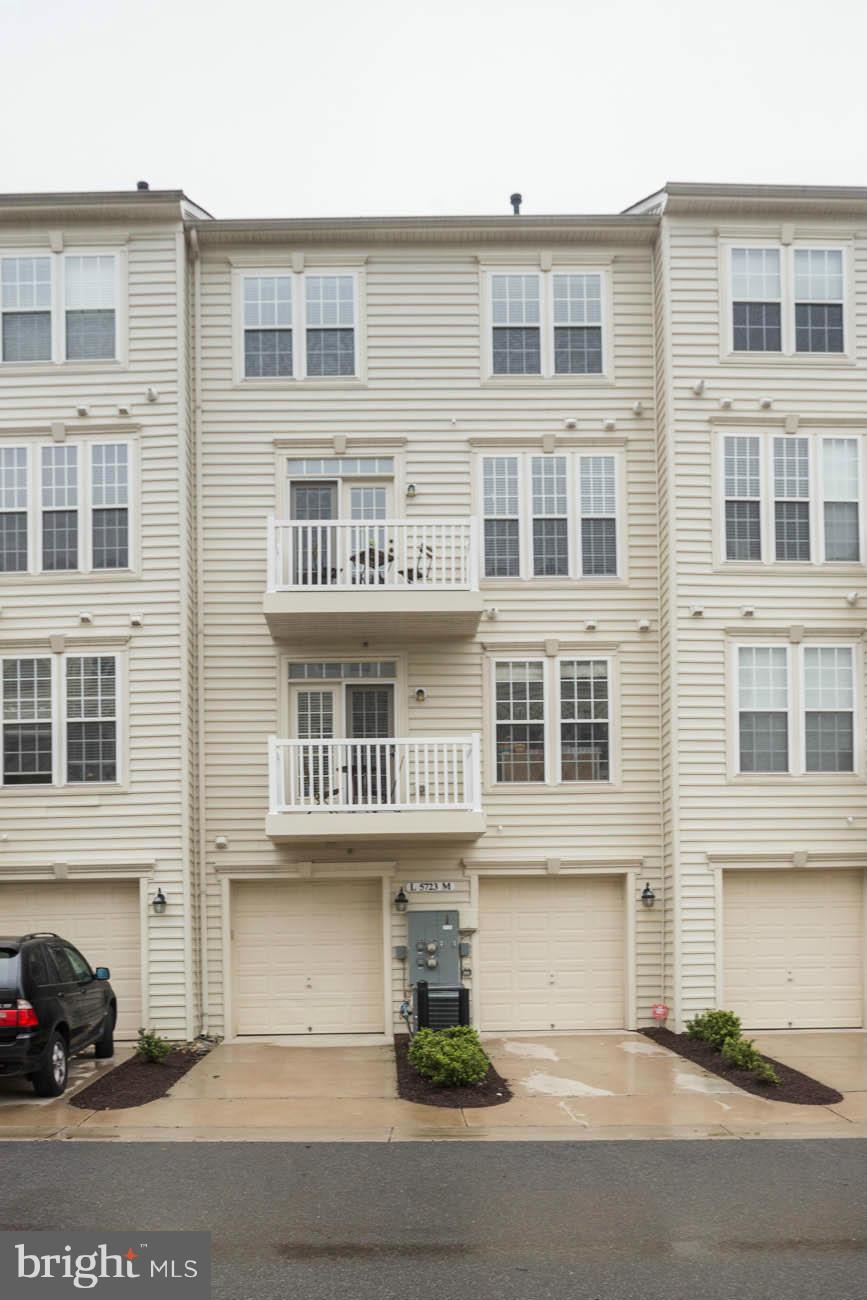5723 Callcott Way, Unit M Alexandria, VA 22312 - Photo 27 of 28 a front view of a building with a street