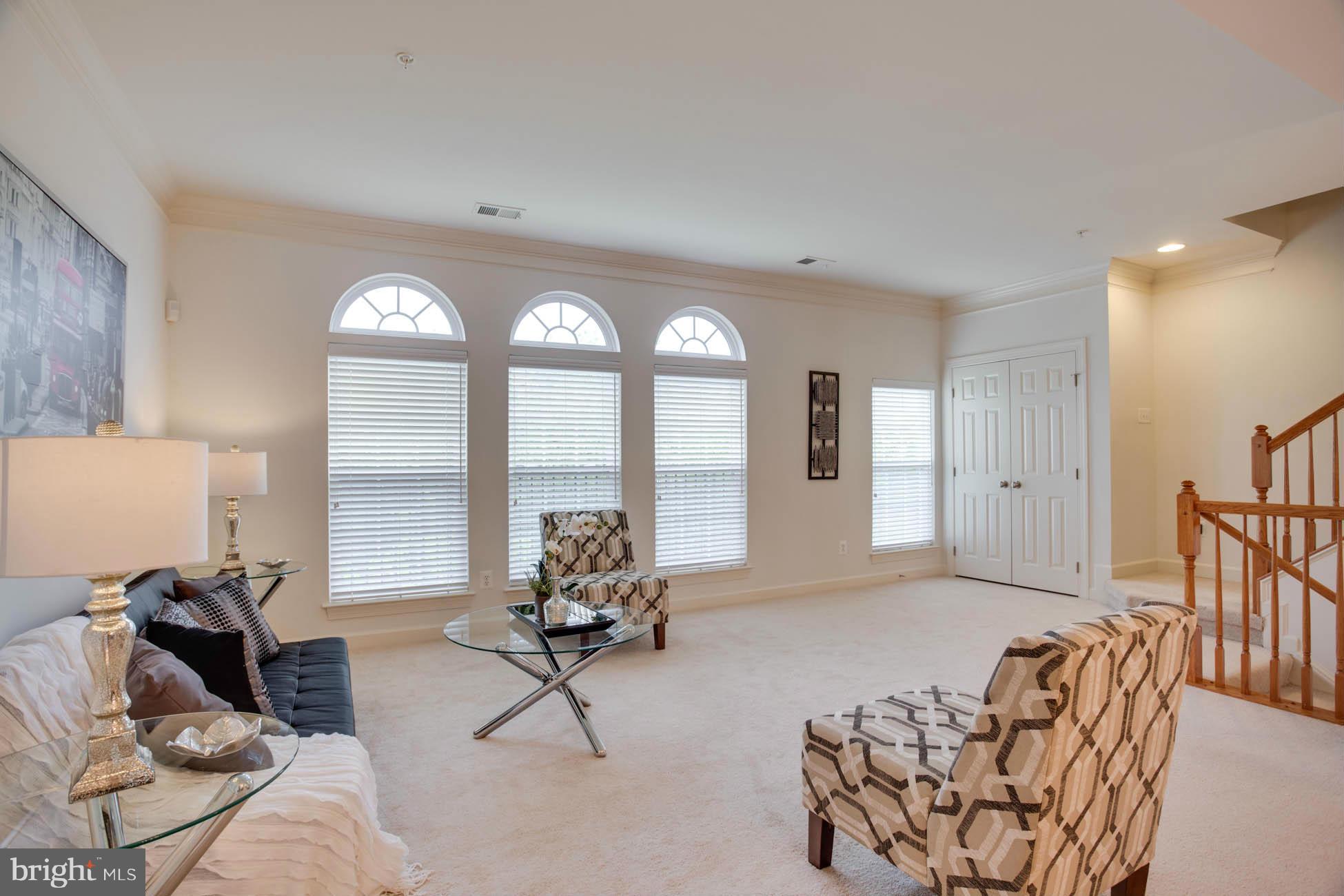 5723 Callcott Way, Unit M Alexandria, VA 22312 - Photo 5 of 28 a living room with furniture and a large window