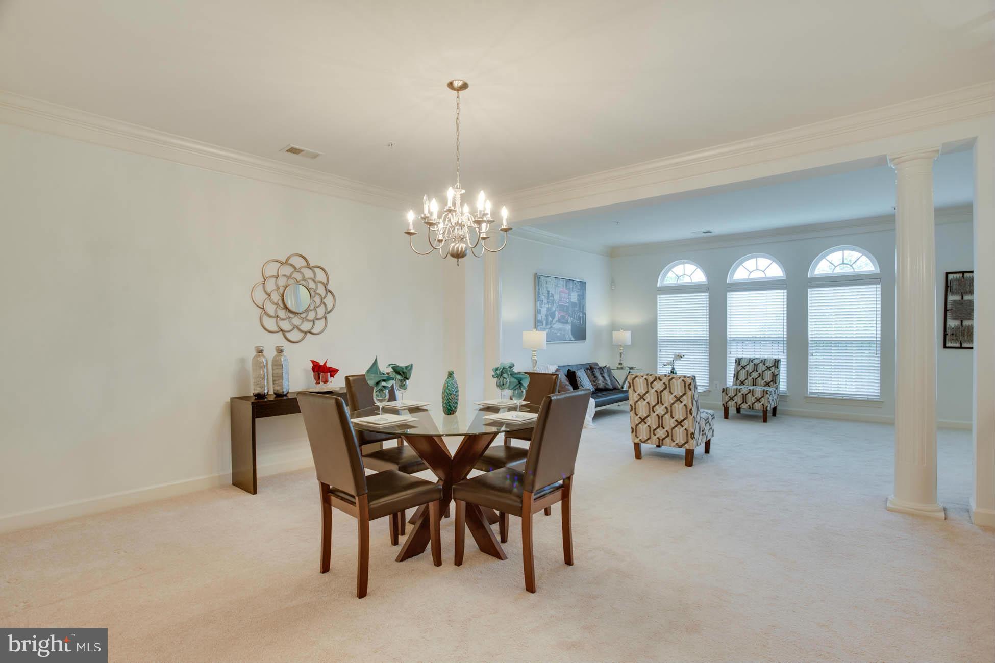 5723 Callcott Way, Unit M Alexandria, VA 22312 - Photo 8 of 28 a dining room with furniture and a chandelier