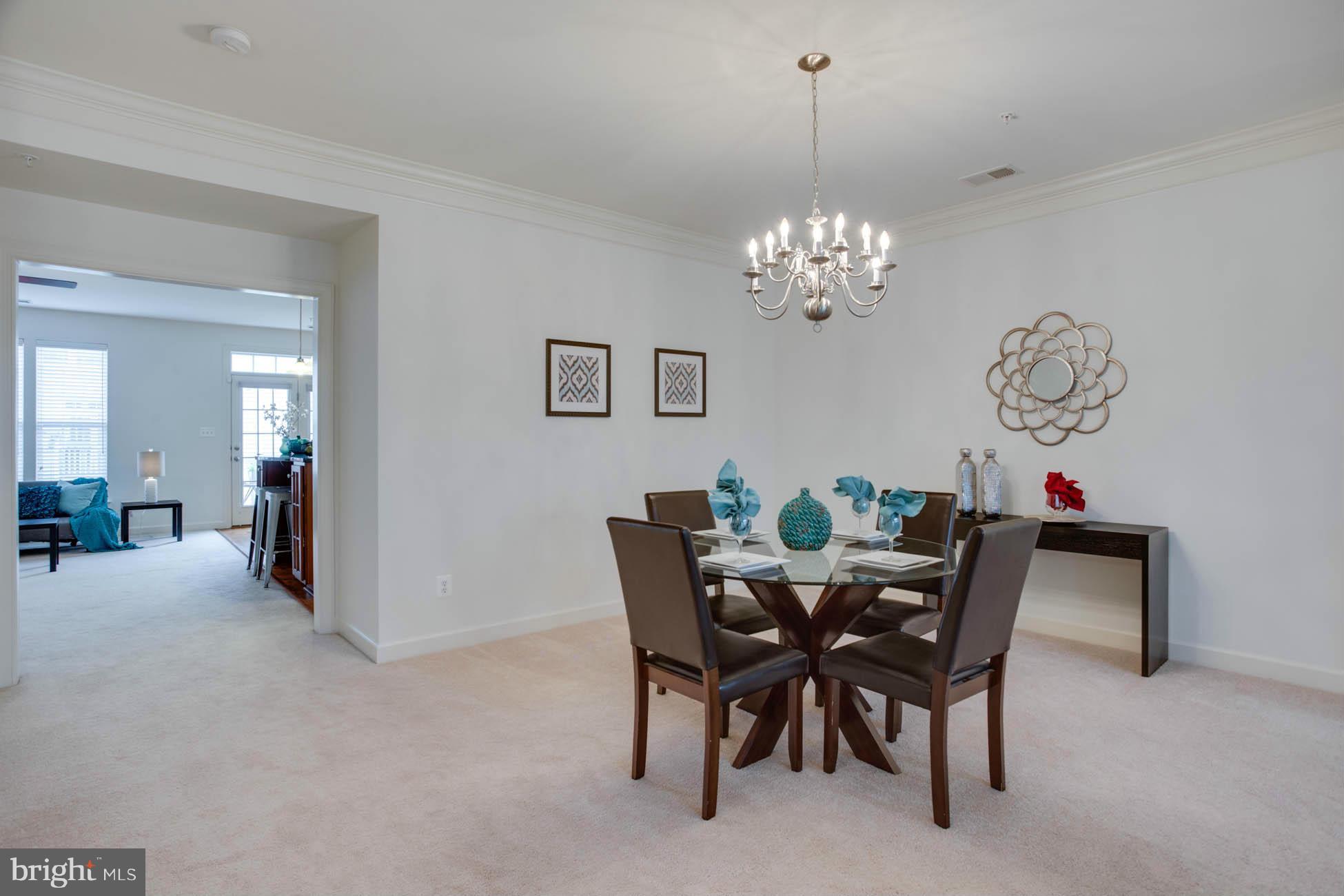 5723 Callcott Way, Unit M Alexandria, VA 22312 - Photo 9 of 28 a view of a dining room with furniture and chandelier