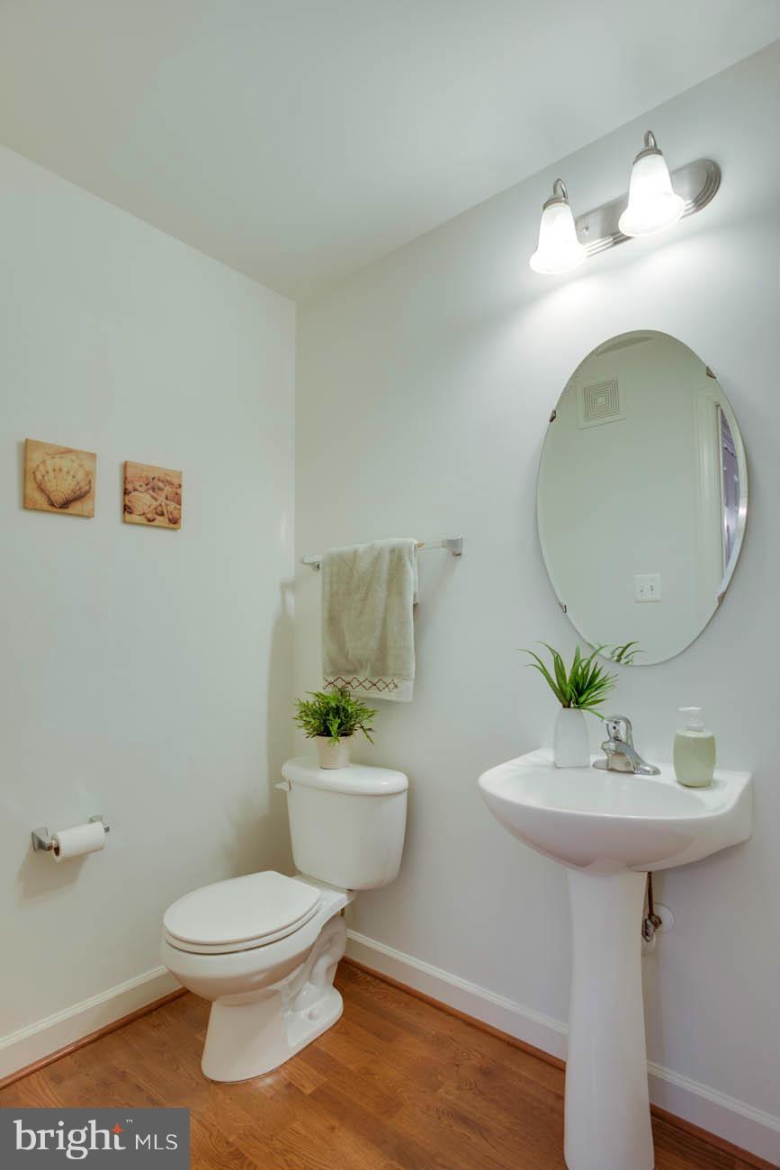 5723 Callcott Way, Unit M Alexandria, VA 22312 - Photo 10 of 28 a bathroom with a toilet sink and mirror