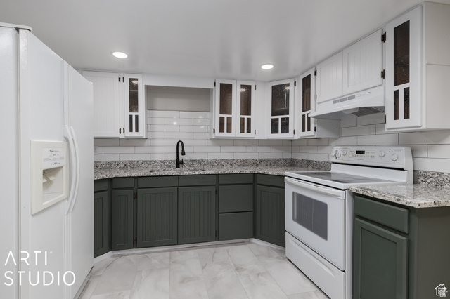 2807 North Ogden Canyon Road Eden, UT 84310 - Photo 36 of 72 Kitchen featuring two-tone cabinetry, white subway tile backsplash, granite-style countertops, black gooseneck faucet, and integrated white appliances