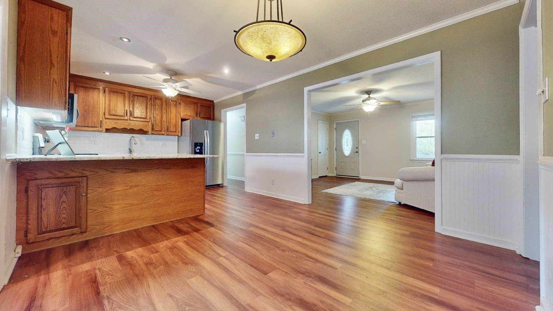 826 Chip Circle Cary, NC 27513 - Photo 11 of 44 a view of a kitchen with kitchen island a sink stainless steel appliances and cabinets