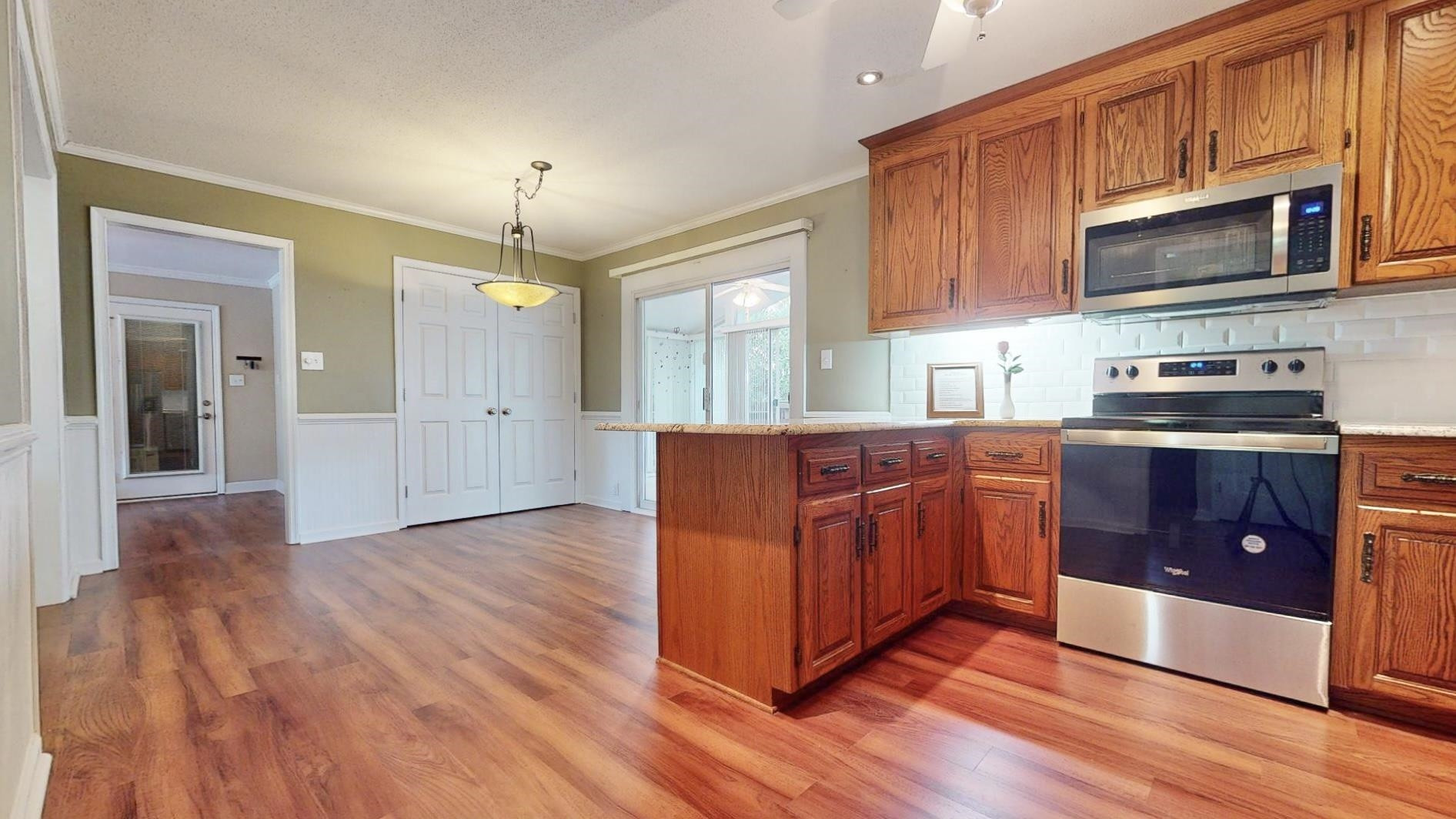 826 Chip Circle Cary, NC 27513 - Photo 14 of 44 a kitchen with stainless steel appliances granite countertop a stove a sink dishwasher and a microwave oven with wooden floor