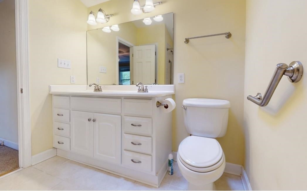826 Chip Circle Cary, NC 27513 - Photo 23 of 44 a bathroom with a granite countertop toilet sink and mirror