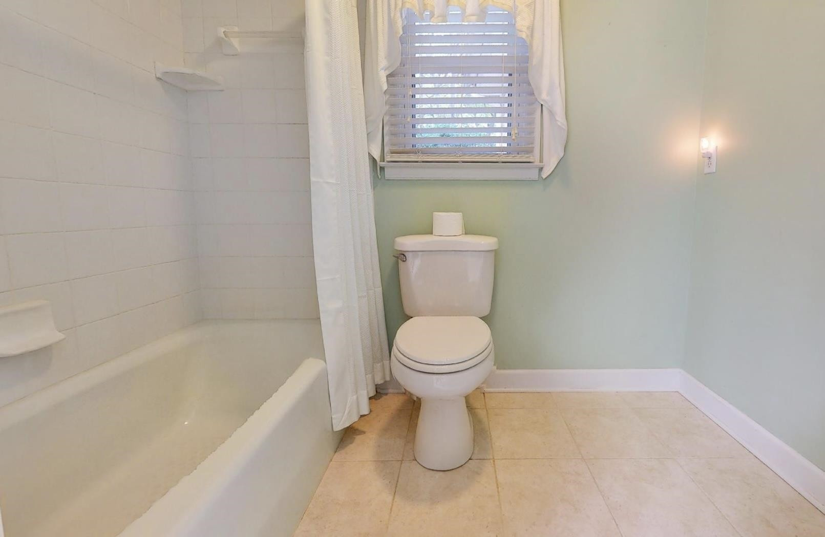 826 Chip Circle Cary, NC 27513 - Photo 27 of 44 a bathroom with a toilet and a bathtub
