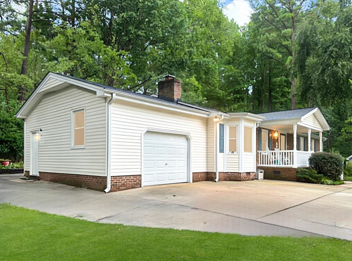 826 Chip Circle Cary, NC 27513 - Photo 4 of 44 a view of a white house with a yard and large trees