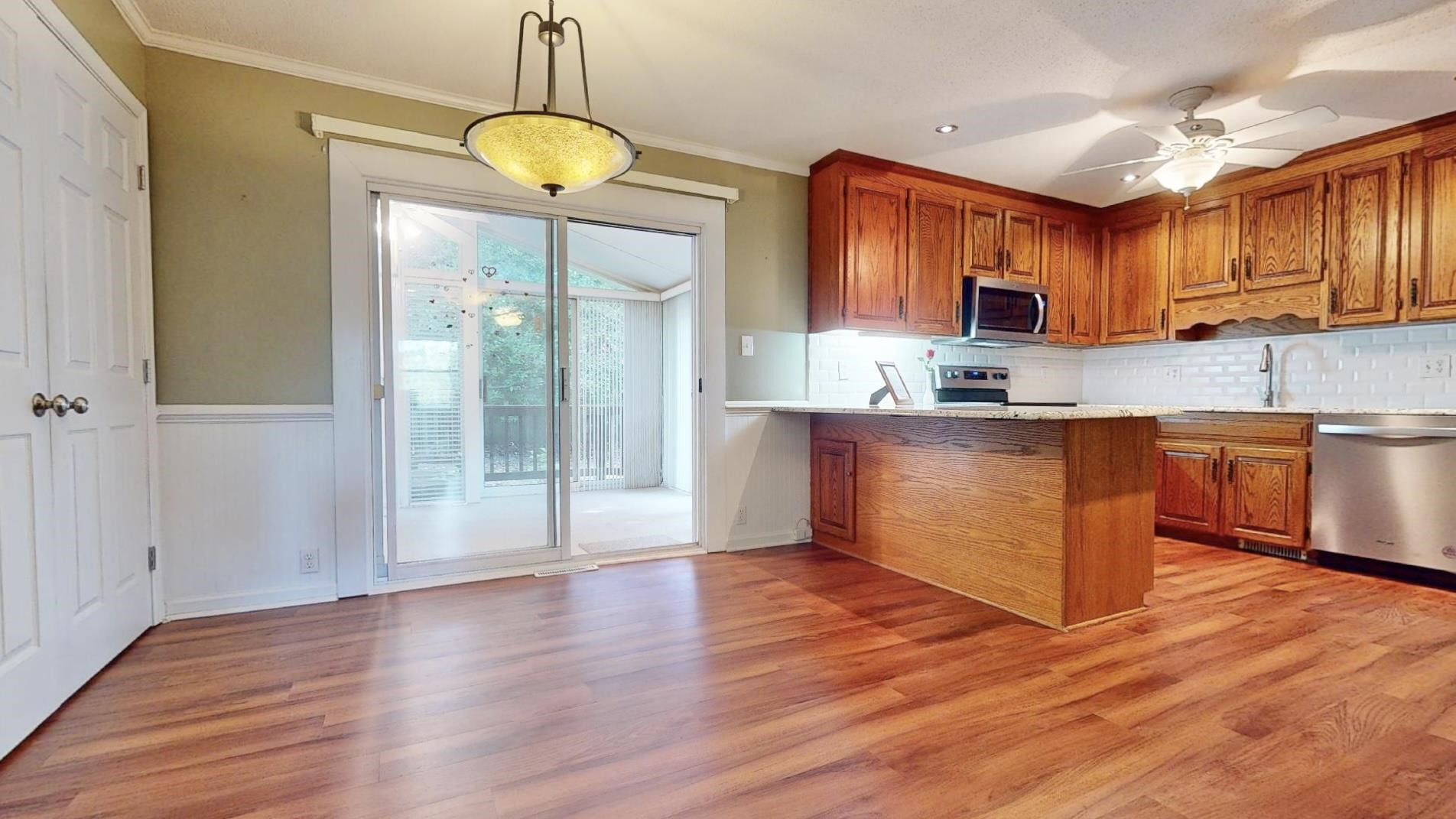 826 Chip Circle Cary, NC 27513 - Photo 9 of 44 a kitchen with stainless steel appliances granite countertop a stove a sink dishwasher and a refrigerator with wooden floor