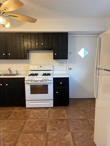 a kitchen with a stove and a refrigerator