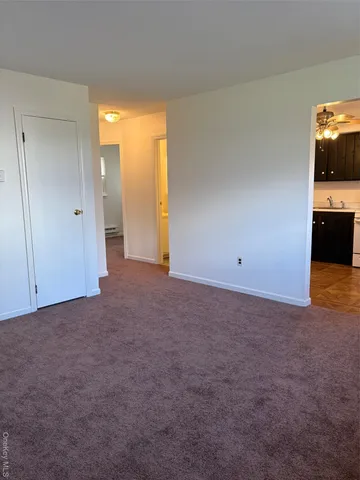 a view of a room with a kitchen