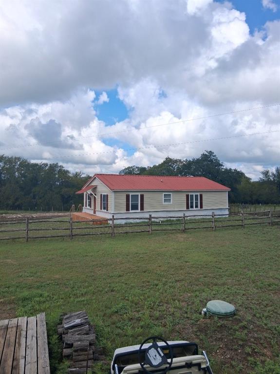 a view of a lake with a big yard and large trees